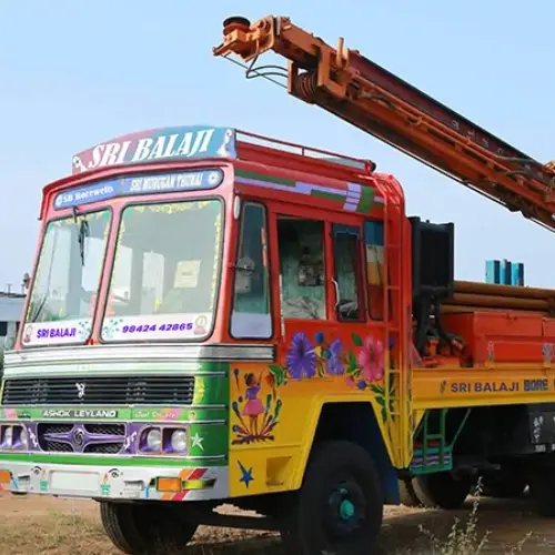 A truck equipped with a crane, prepared to perform heavy borewell cleaning and drilling services.