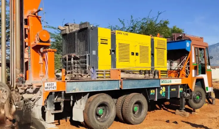 An enormous truck used for home drilling service with a giant machine on its flatbed